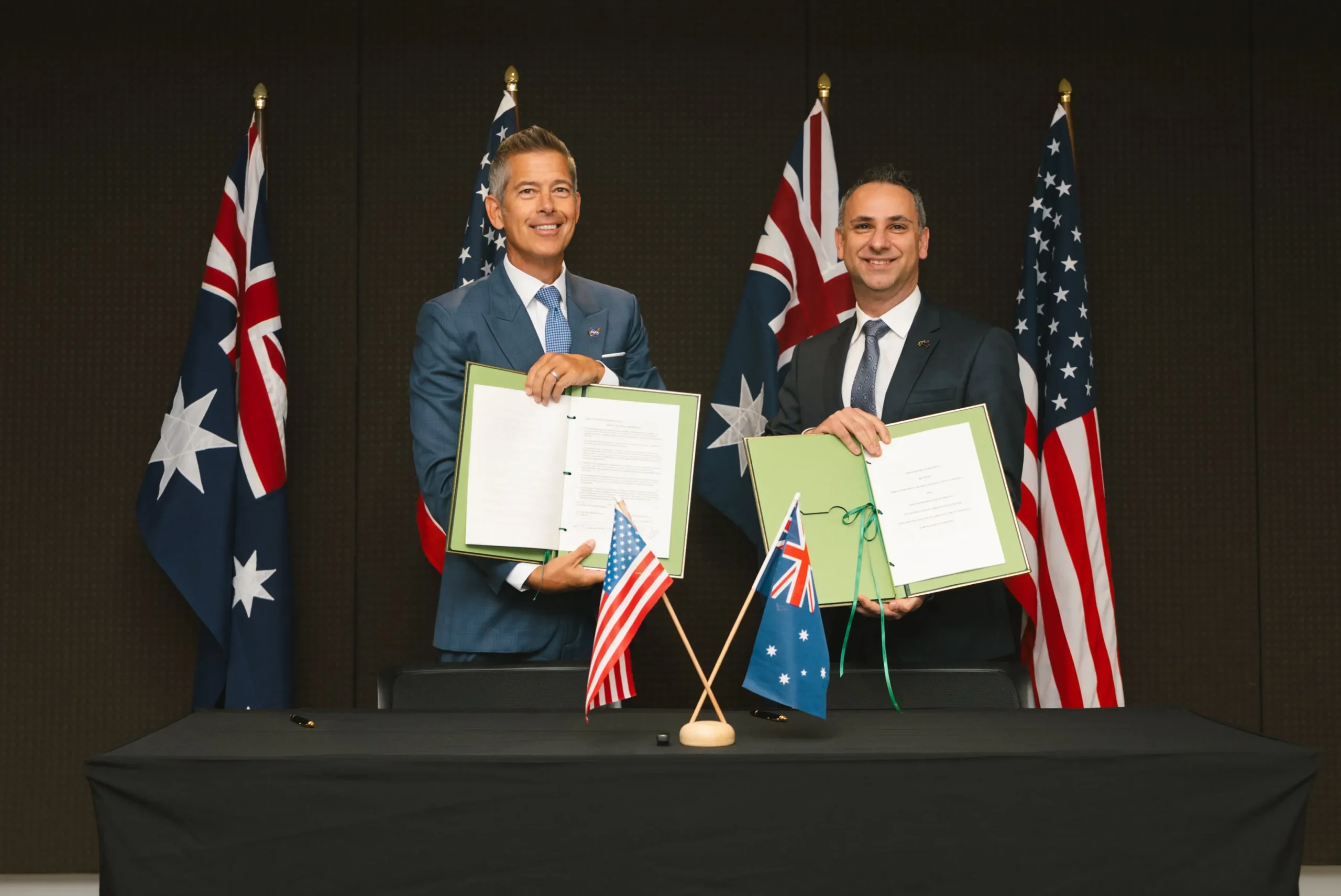 Sean Duffy (NASA) and Enrico Palermo (ASA) holding the signed US–Australia space cooperation framework agreement in Sydney, September 2025.