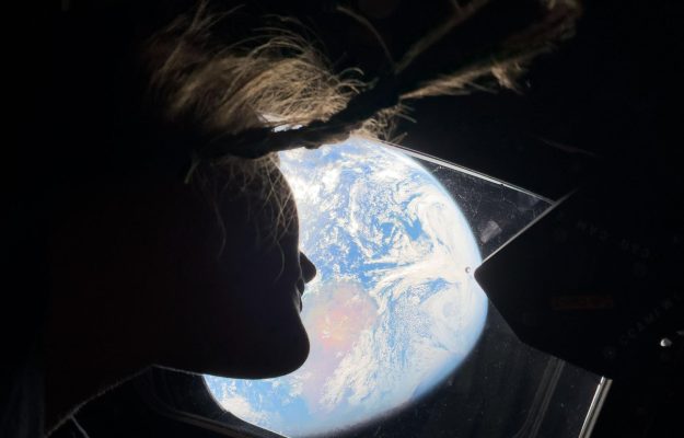 Christina Koch looking at Earth from Orion Artemis II NASA