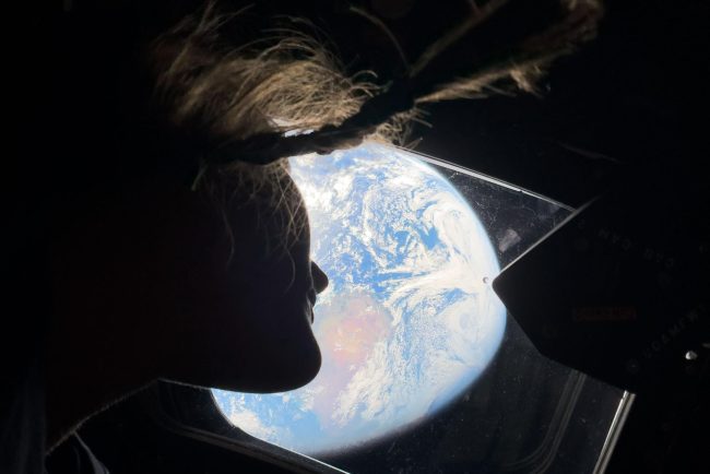 Christina Koch looking at Earth from Orion Artemis II NASA