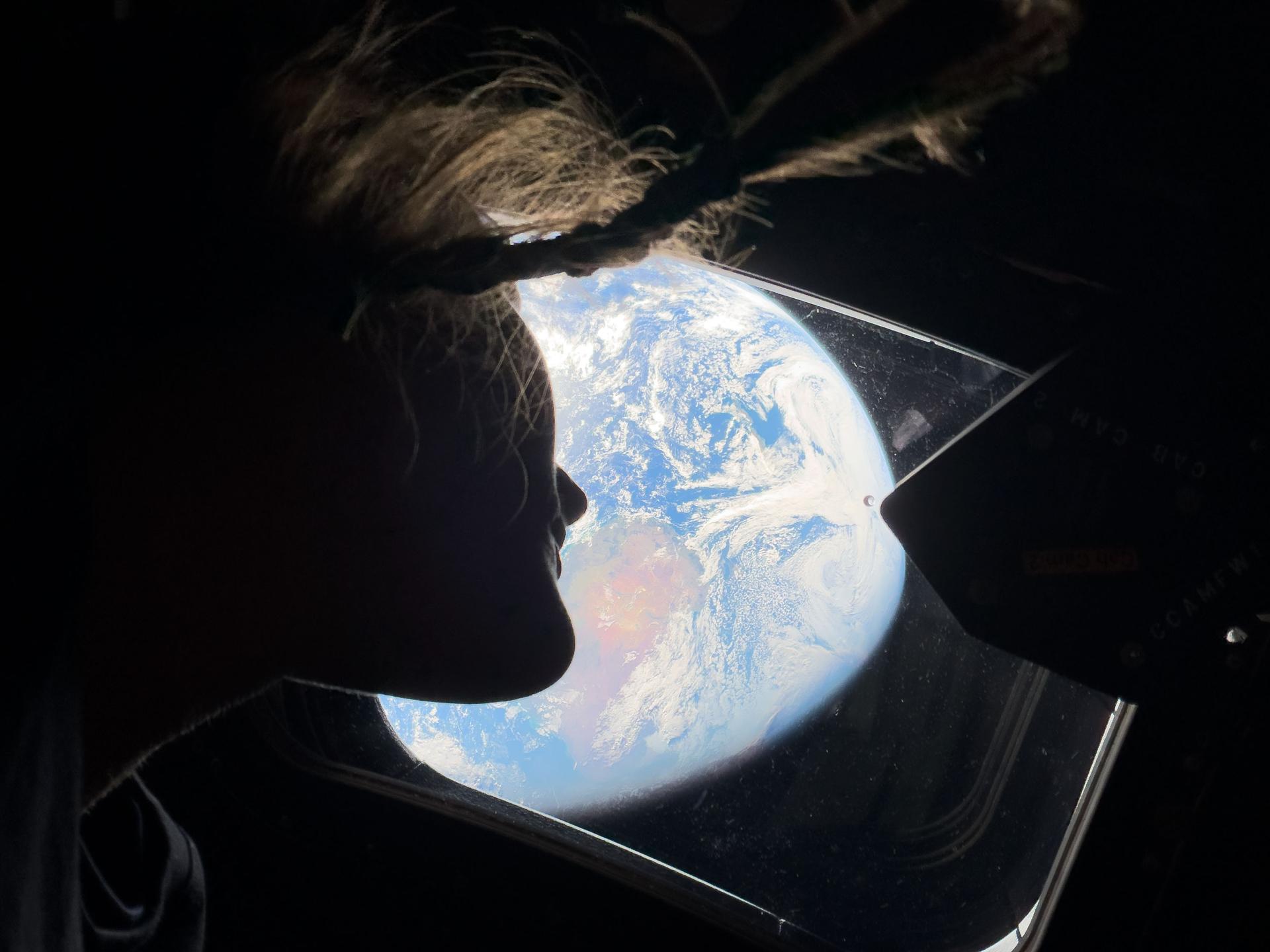 Christina Koch looking at Earth from Orion Artemis II NASA